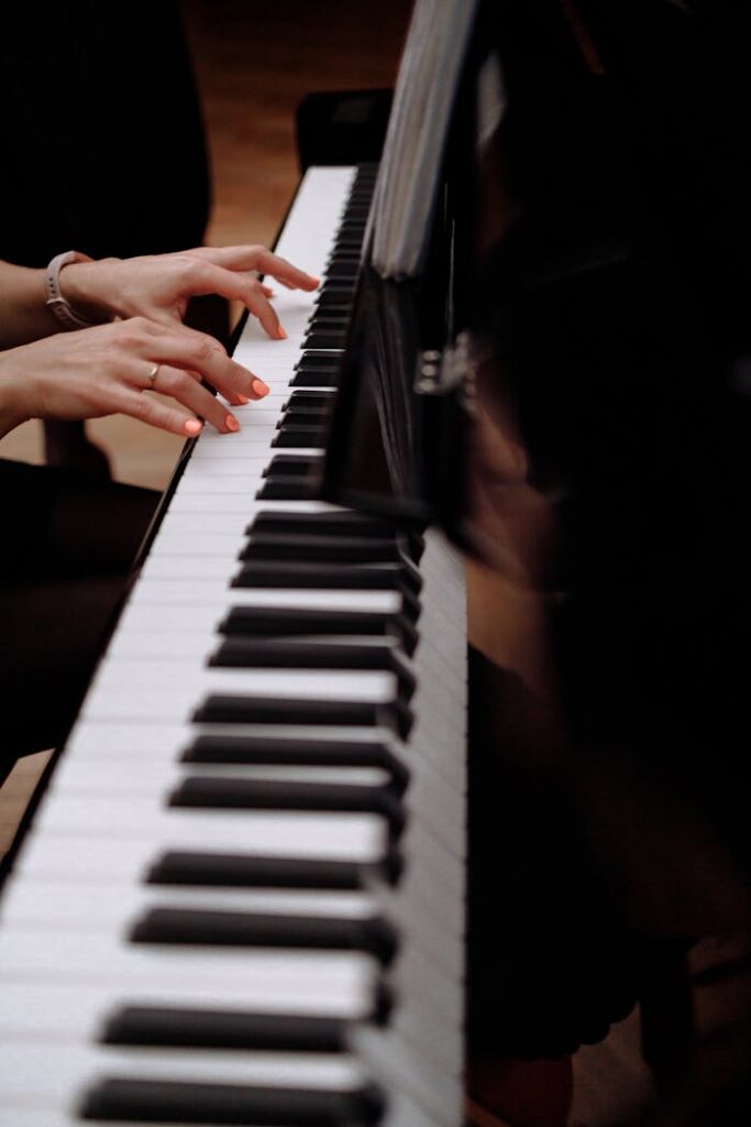 Elegant fingers playing piano keys in focus for a musical performance.